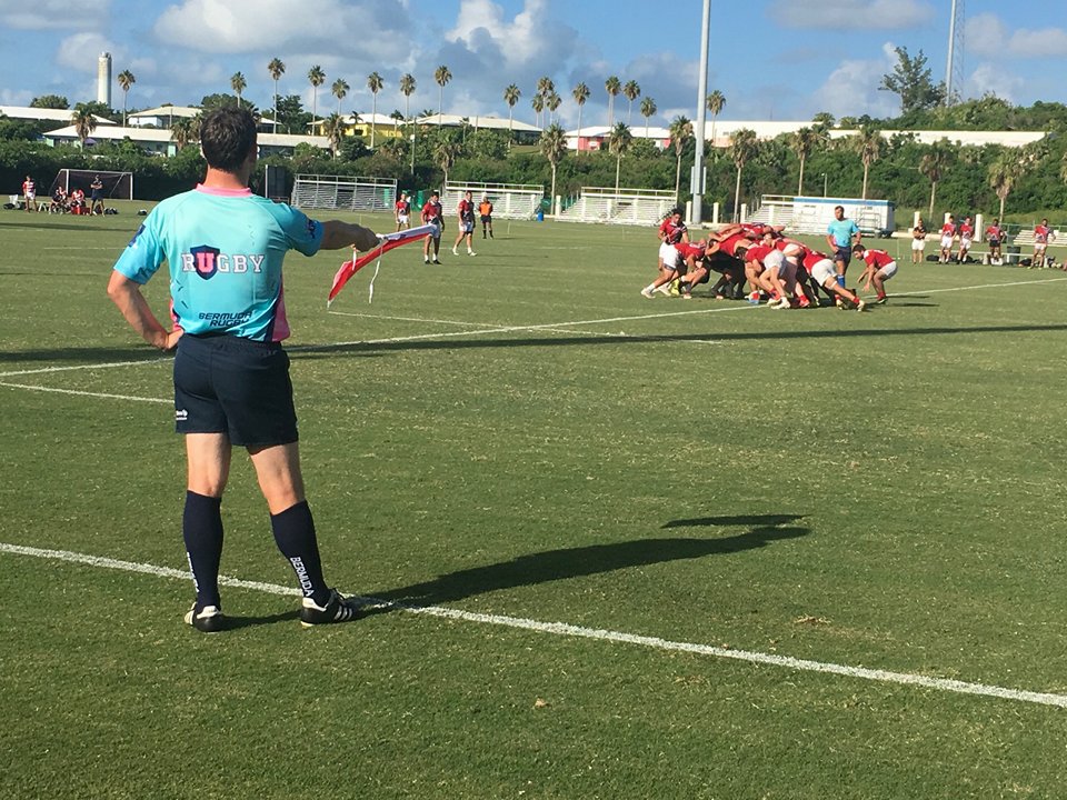 Referee with flags on the rugby field