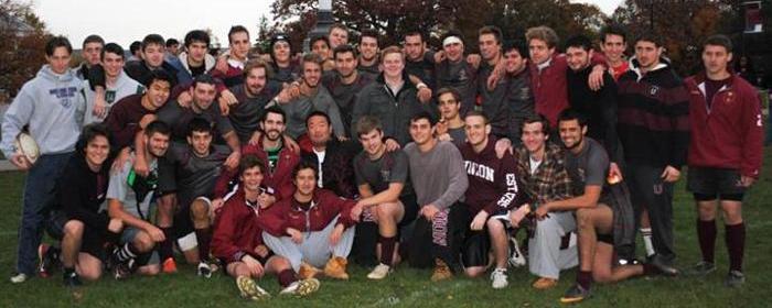 Group gathered for a team photo on the rugby field