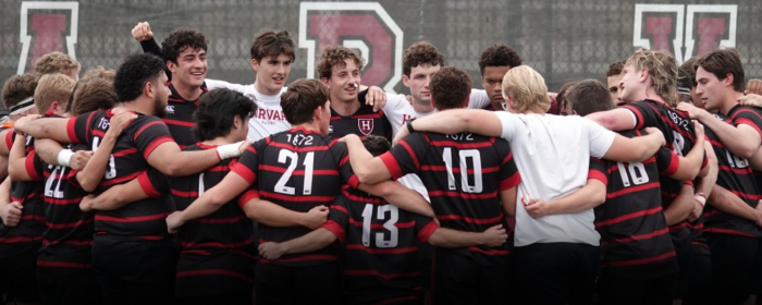 men's team huddles on the field
