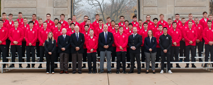 team in front of the arch