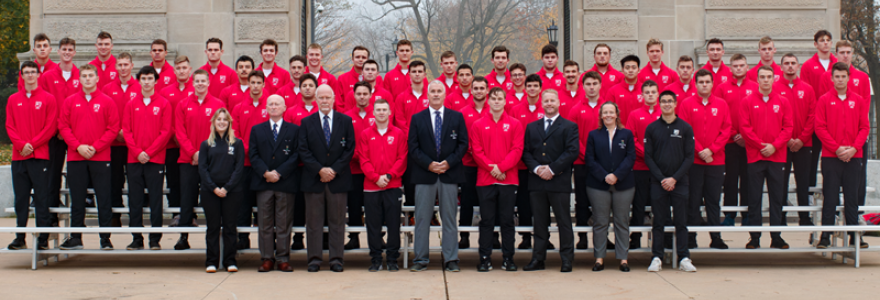 team in front of the arch