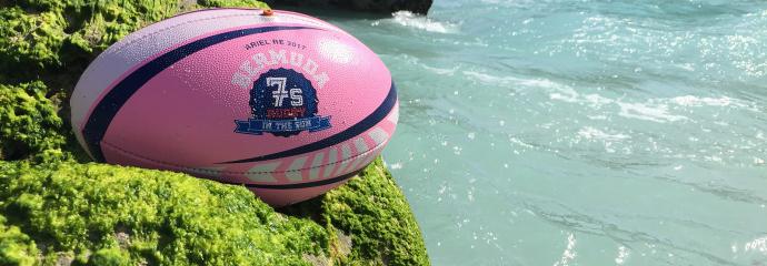 Rugby ball resting on a cliffside 