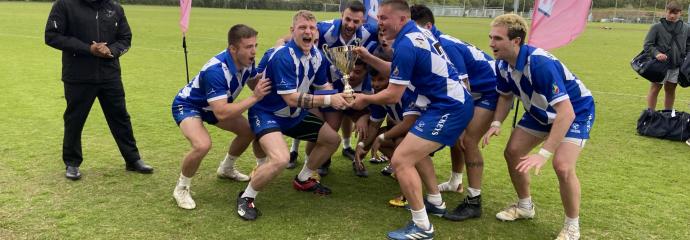 rugby team hoists the cup