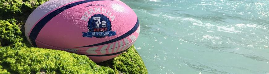 Rugby ball resting on a cliffside 