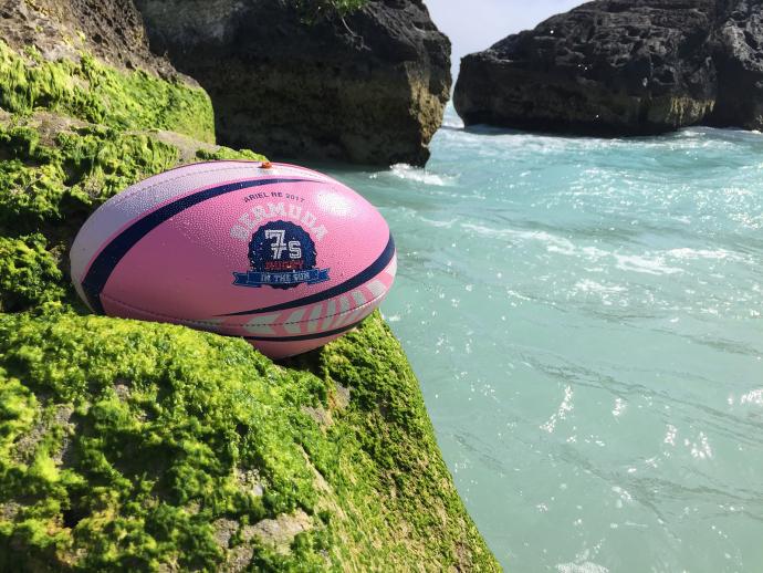 Rugby ball resting on a cliffside 
