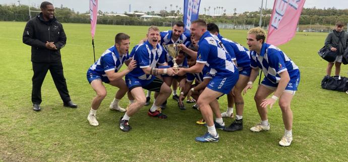 rugby team hoists the cup
