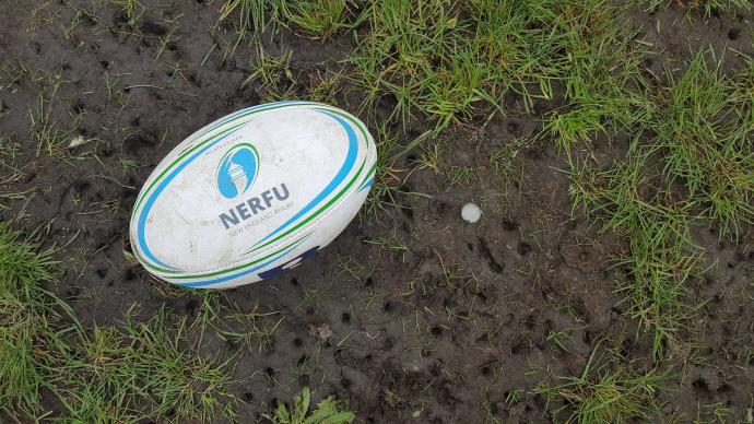 NERFU rugby ball in the dirt with cleat marks